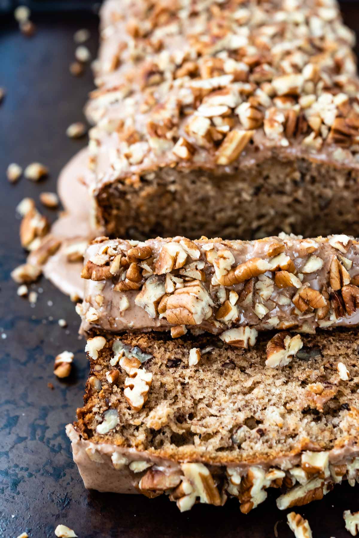 sliced banana nut bread with pecan on top