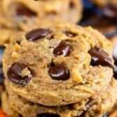 stacked pumpkin cookies with chocolate chips baked in and words on top