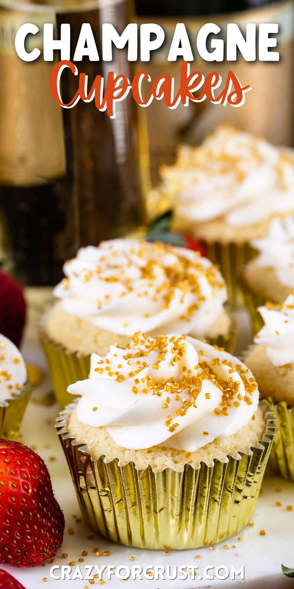 cupcakes in a gold tin with white frosting and gold sprinkles and words on top
