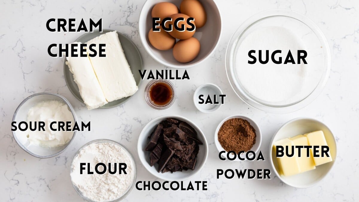 ingredients in cheesecake brownies laid out with words saying the ingredients shown