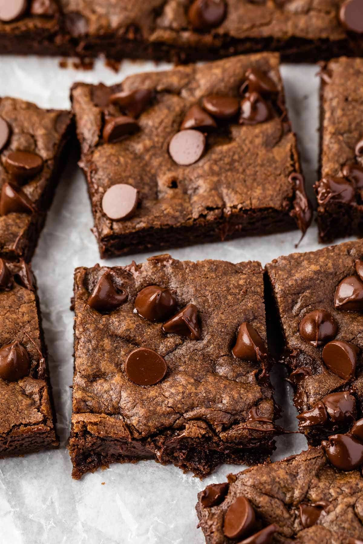 chocolate chip cookie bars laid out on parchment paper