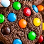 stacked chocolate cookies with colorful m&ms baked in and words on top