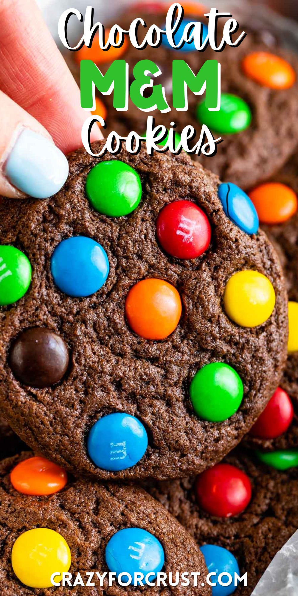 stacked chocolate cookies with colorful m&ms baked in and words on top