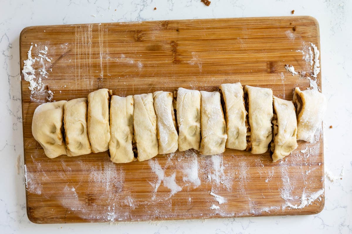 cut cinnamon rolls on cutting board.