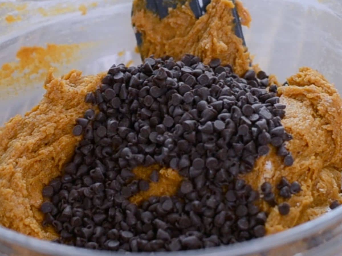pumpkin bread batter in bowl with chocolate chips.