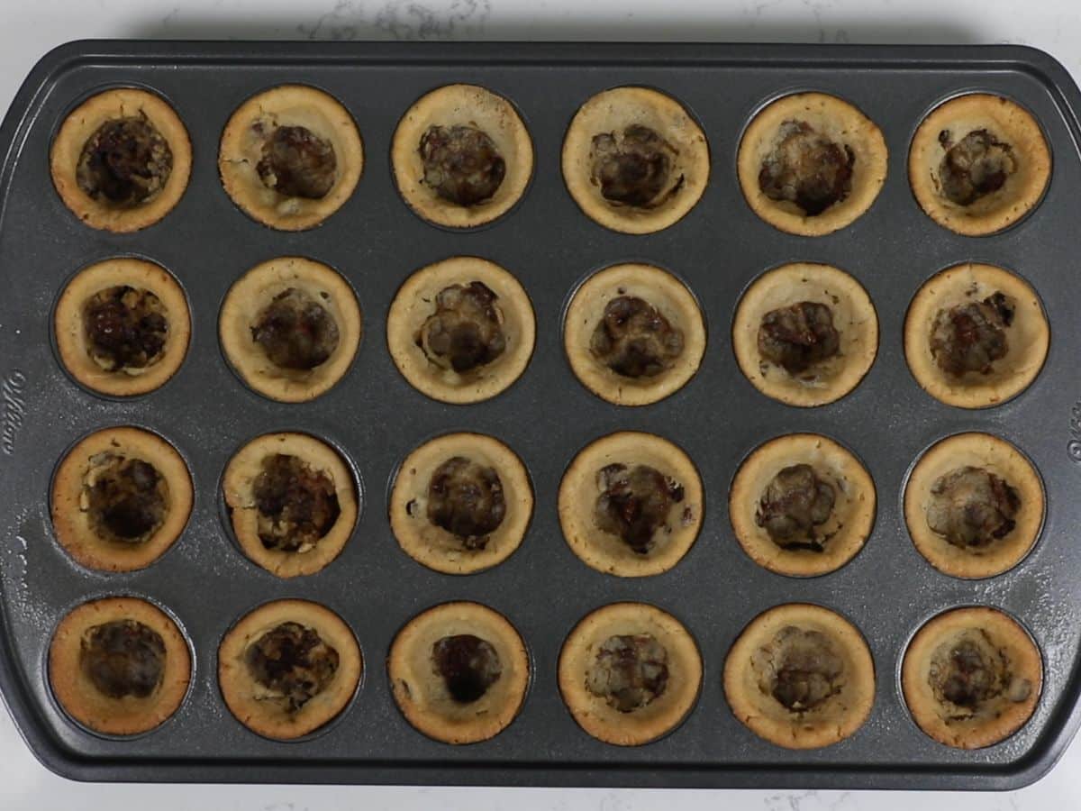 mini muffin pan with baked cookie cups inside