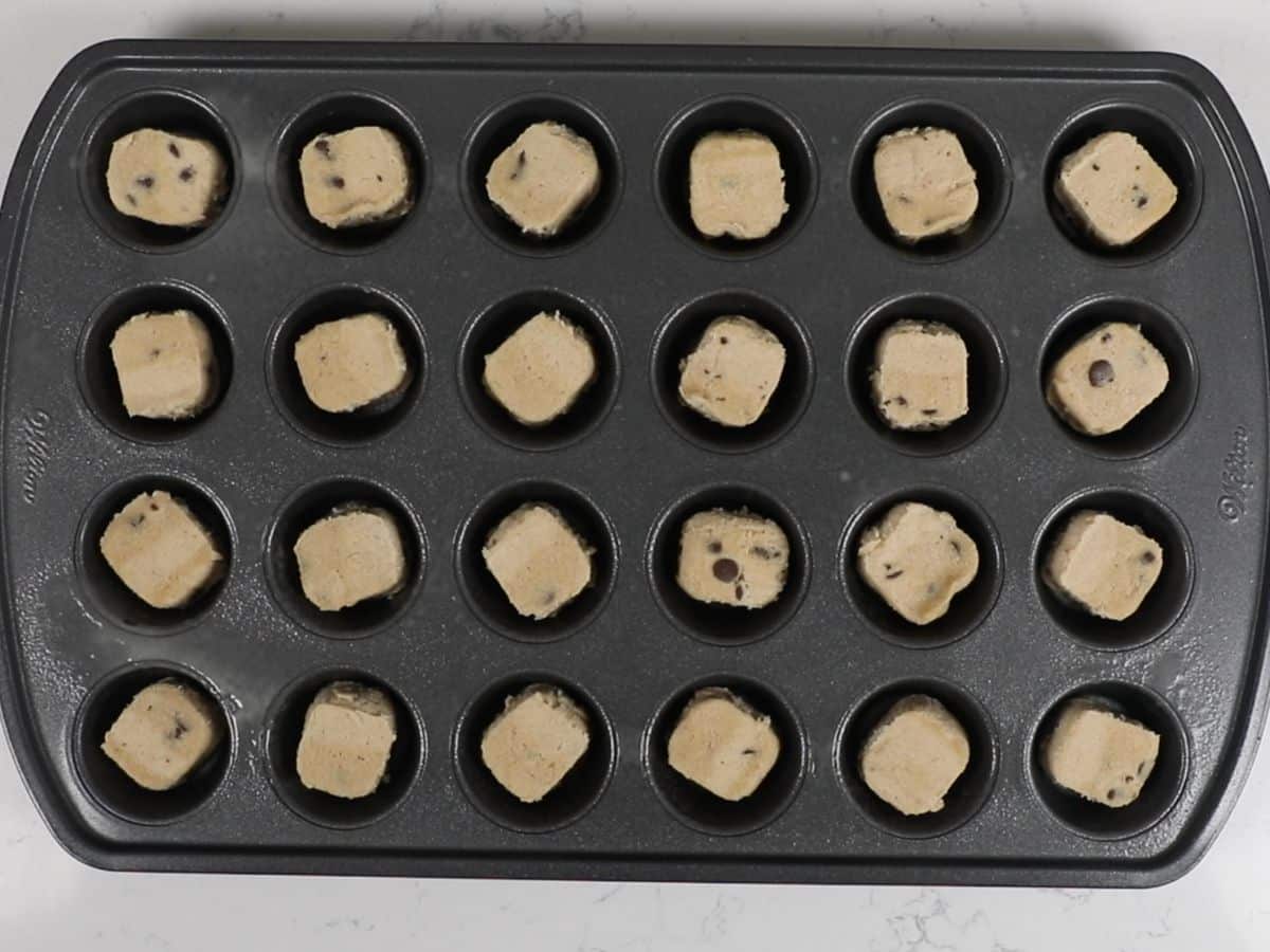 mini muffin pan with cookie dough inside