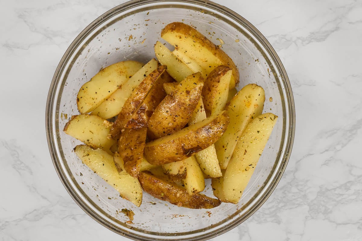 bowl of seasoned potato wedges