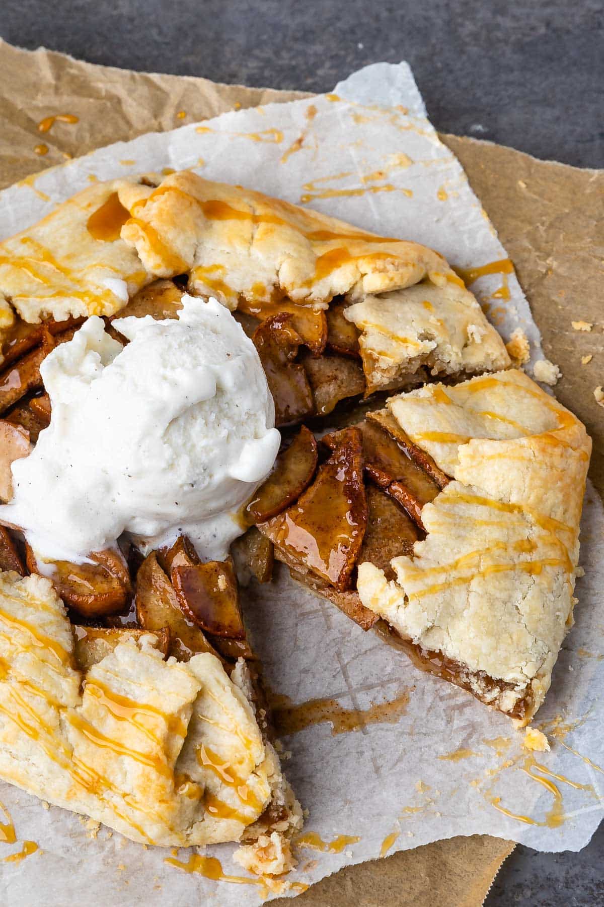 circular pear pastry dessert on parchment paper with ice cream on top