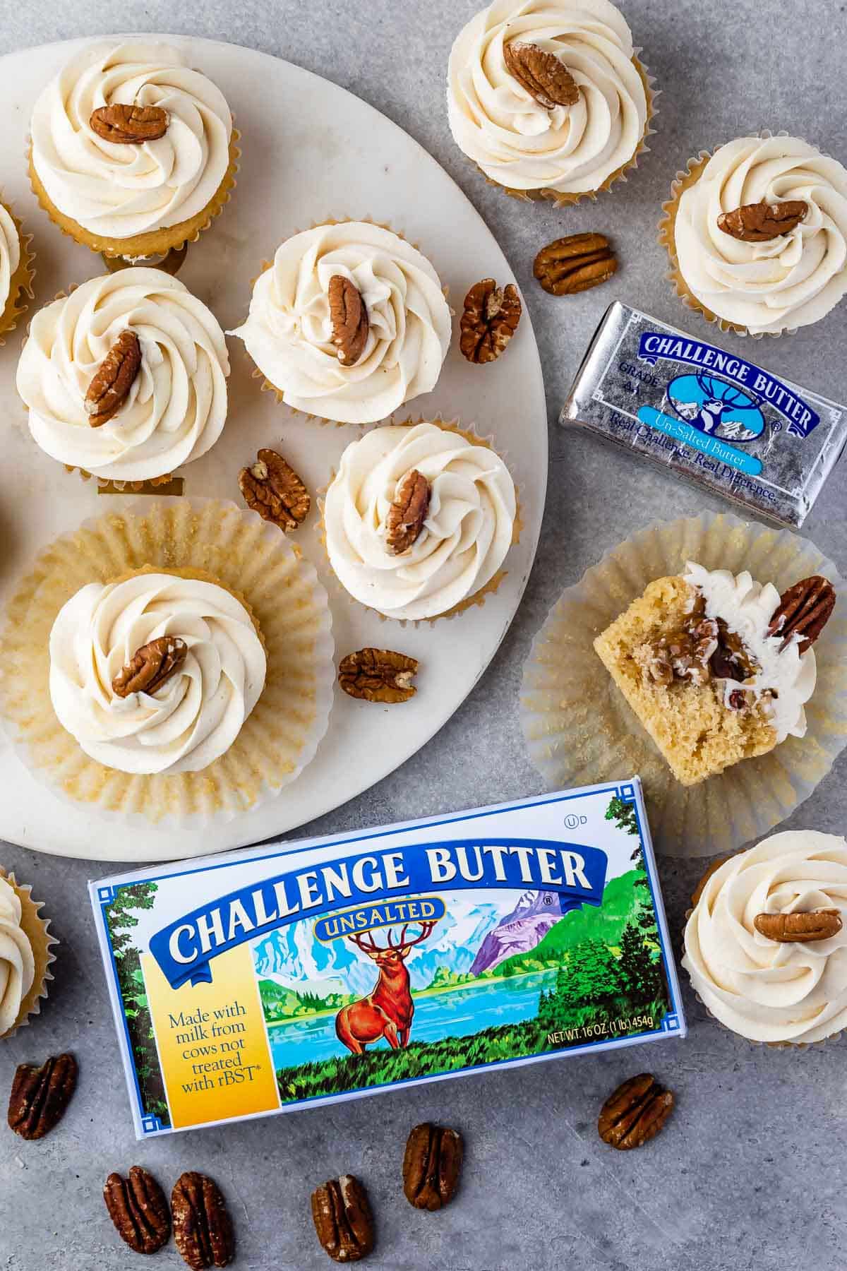pecan cupcakes laid out on a counter with a challenge butter box next to the cupcakes
