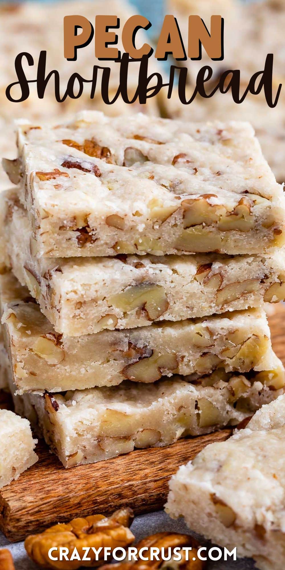 shortbread bars with pecans baked in stacked on a cutting board with words on top