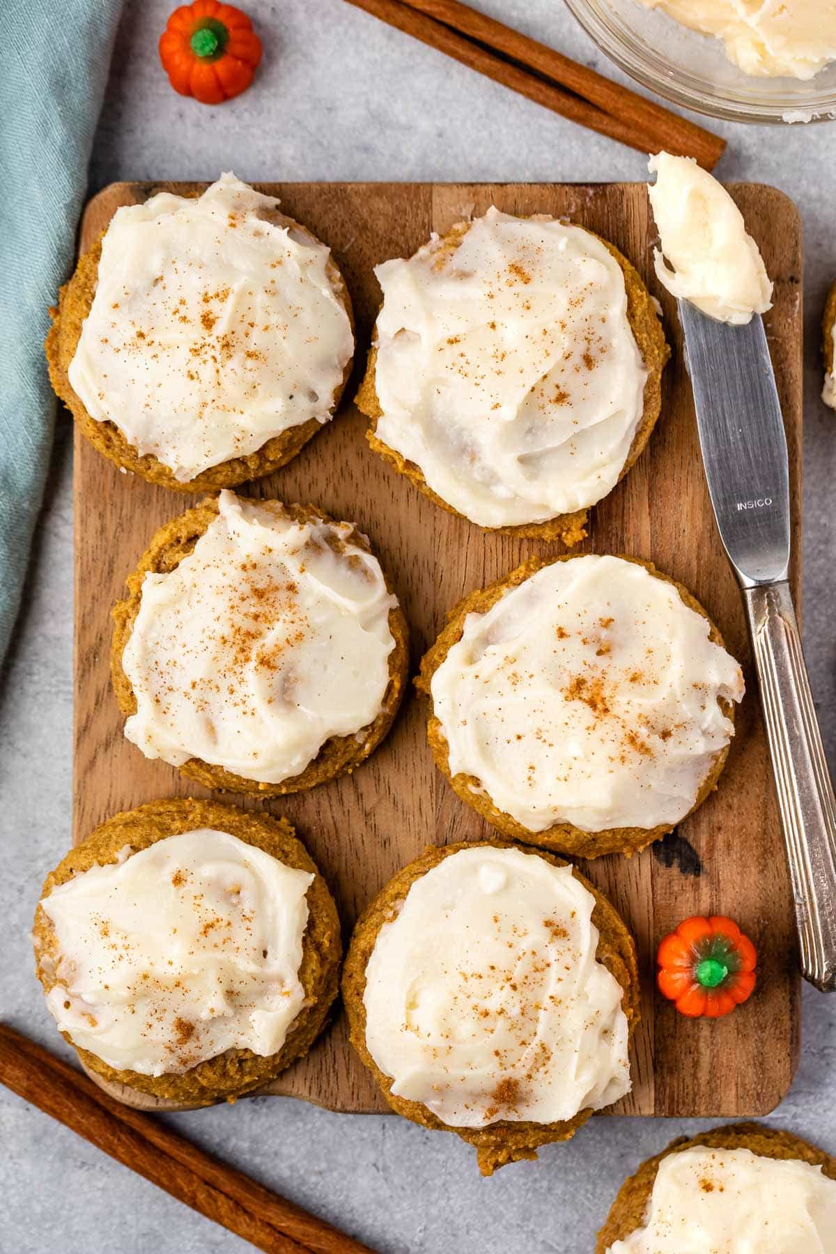 cookies with frosting on top laid out on a cutting board