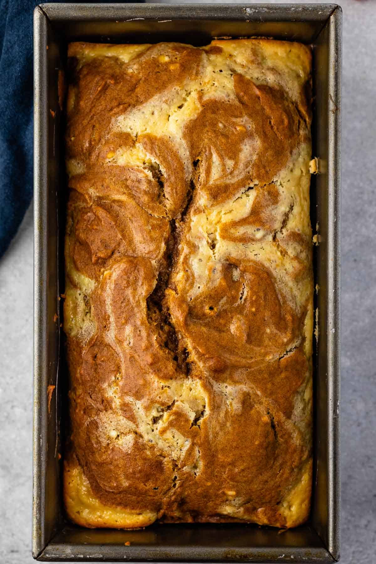 full pumpkin loaf in a grey loaf pan