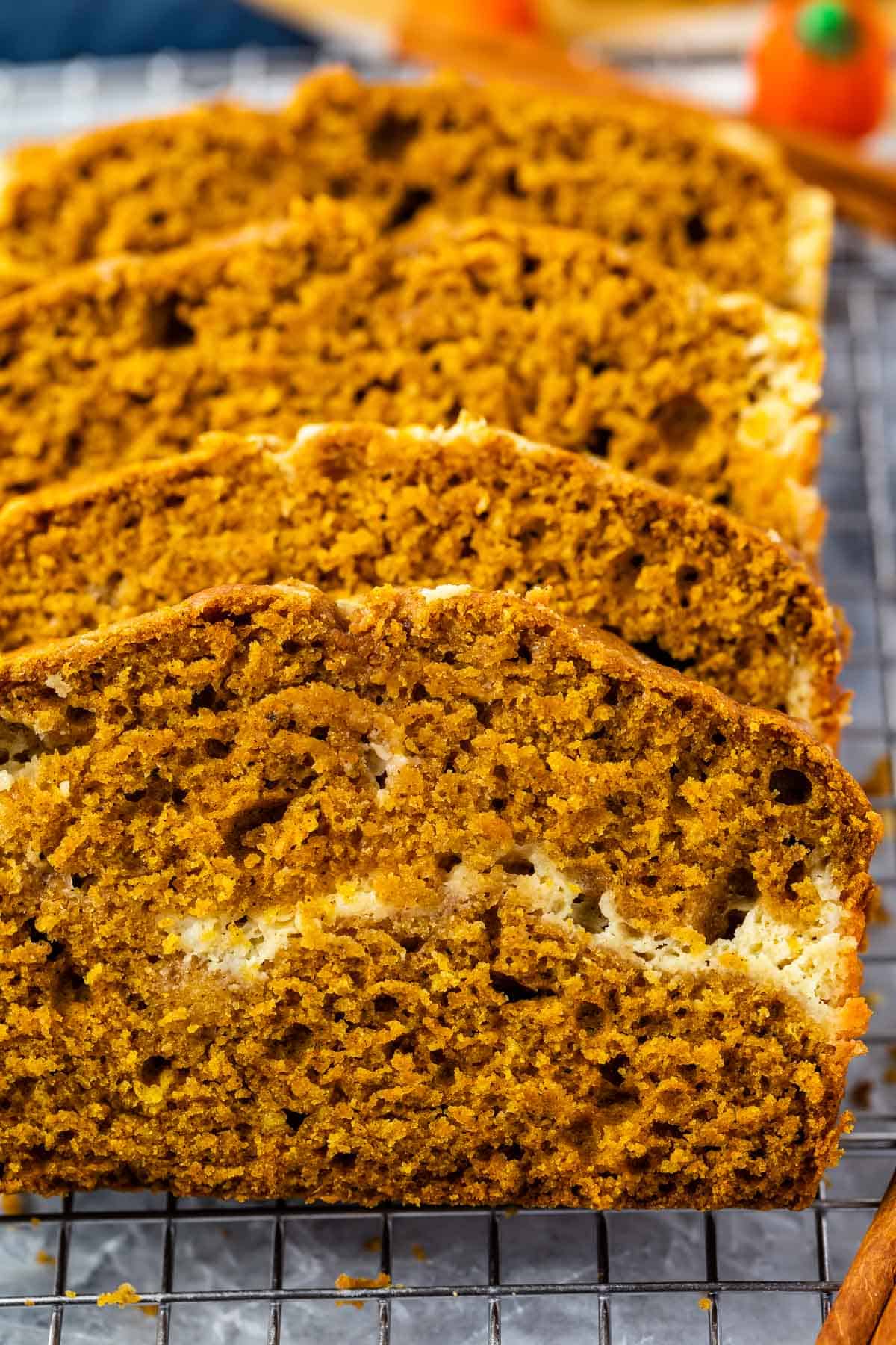 four slices of the pumpkin loaf laying on a drying rack