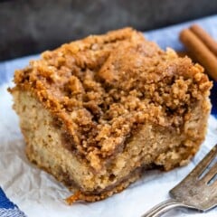 crumb cake on a white towel next to a silver fork