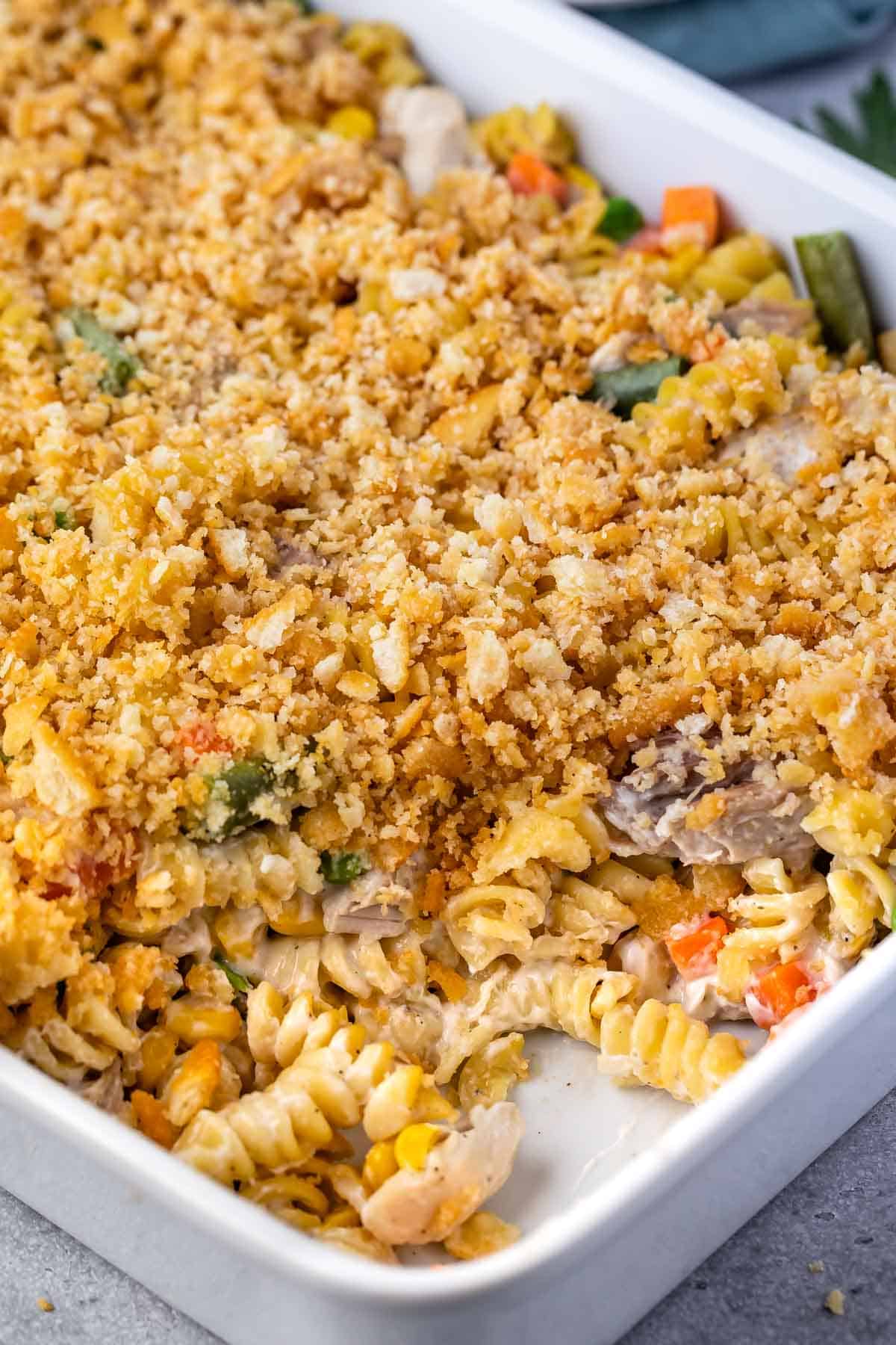 pasta and breadcrumbs and vegetables mixed together in a white pan