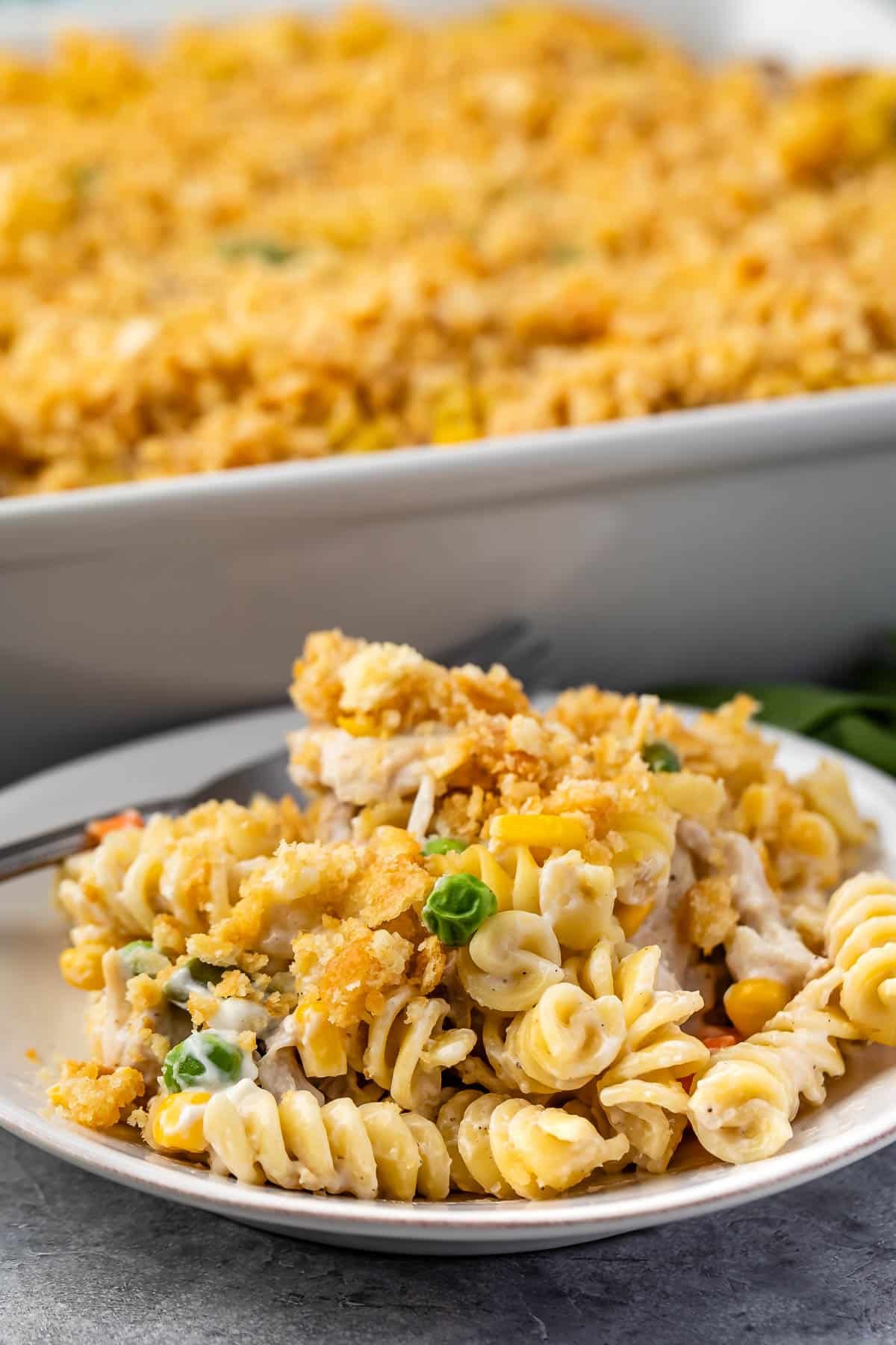 pasta and breadcrumbs and vegetables mixed together on a white plate