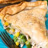 pot pie filled with veggies on a blue plate with words on top