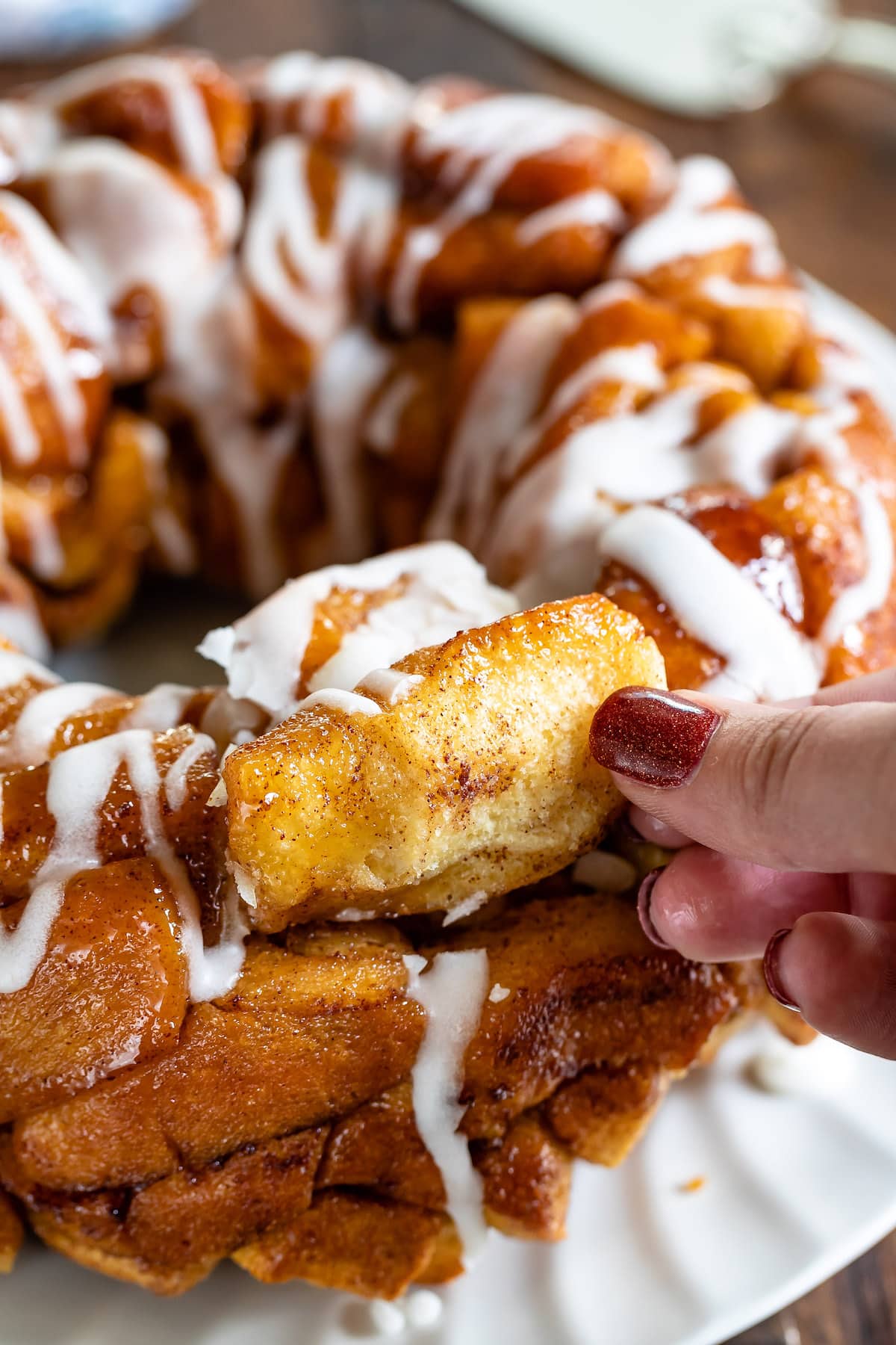fingers pulling piece of monkey bread out