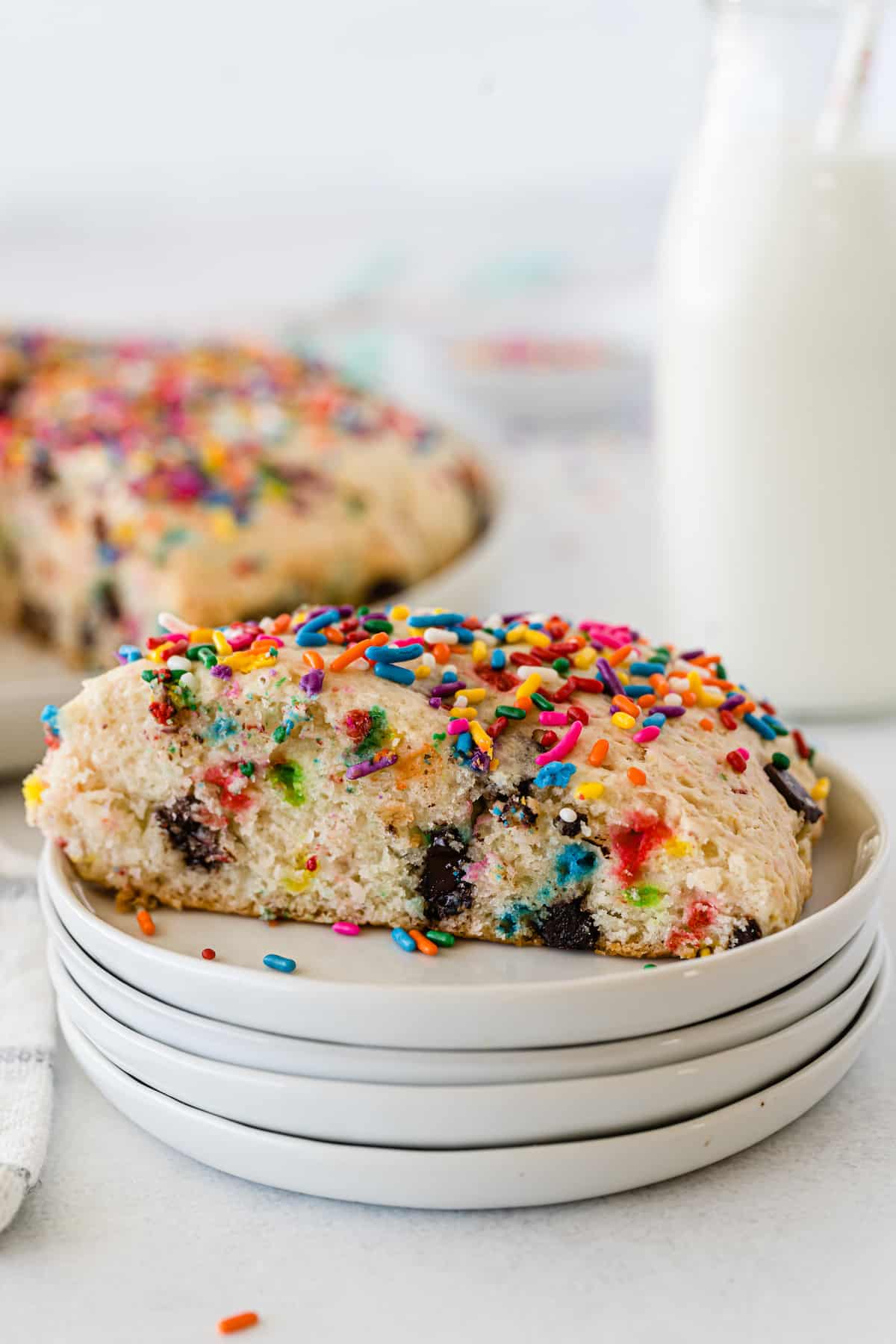 scones with sprinkles and chocolate baked in on a white plate