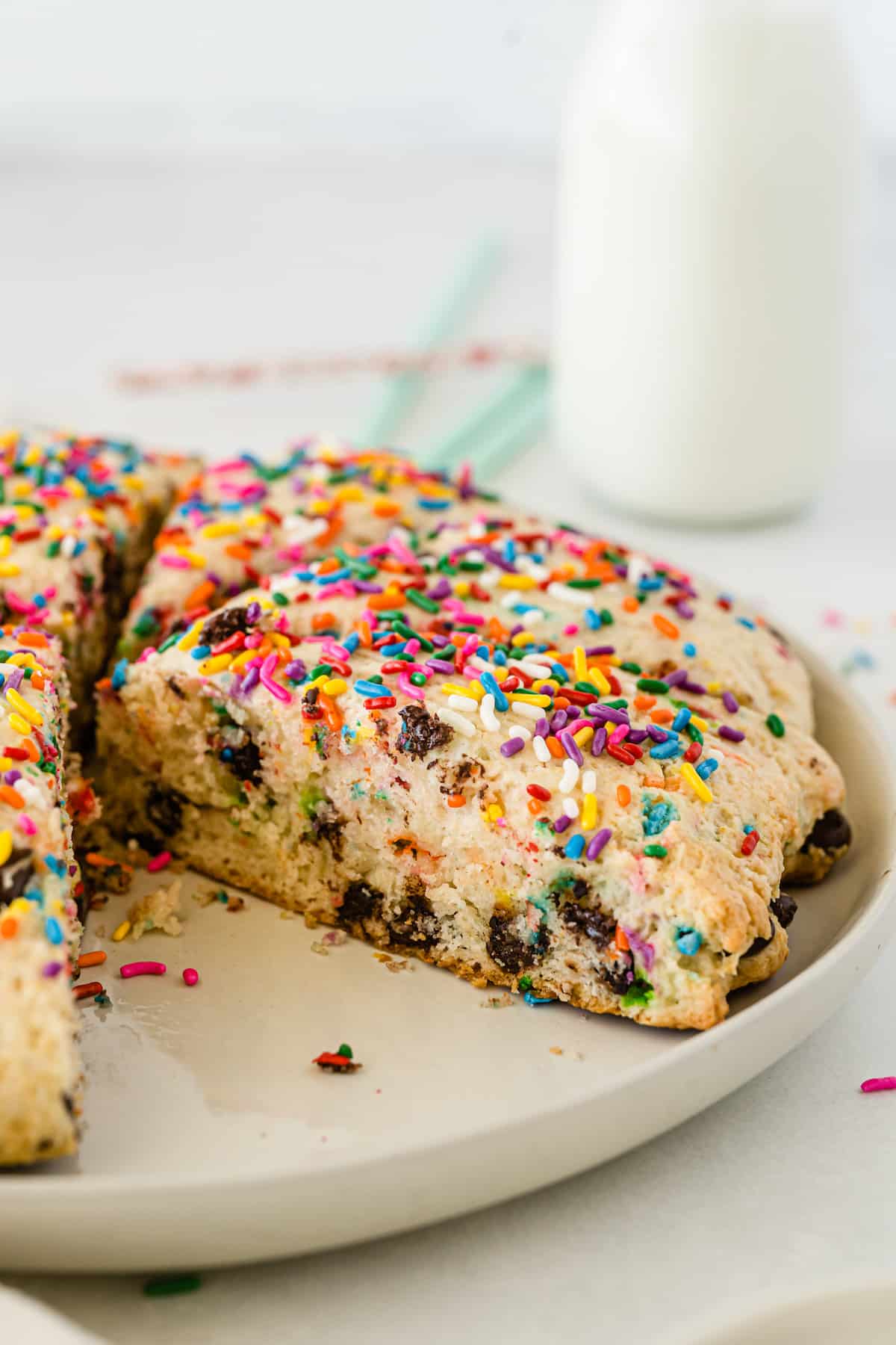 scones with sprinkles and chocolate baked in on a tan plate