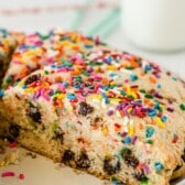 scones with sprinkles and chocolate baked in on a white plate with words on top