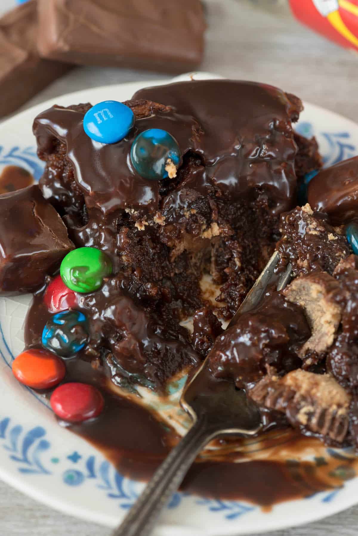 slice of candy pie with m&ms and Rolos on top