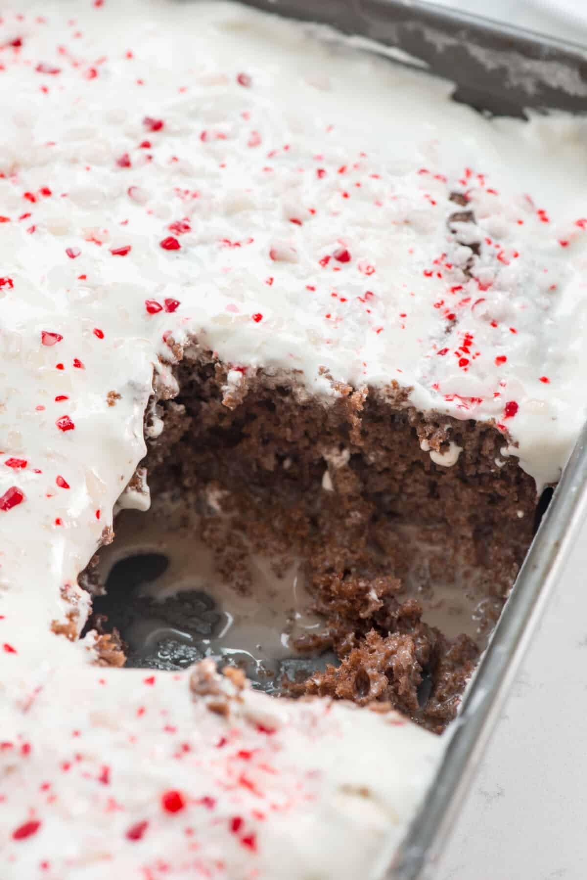 cake with white frosting and crushed peppermint on top
