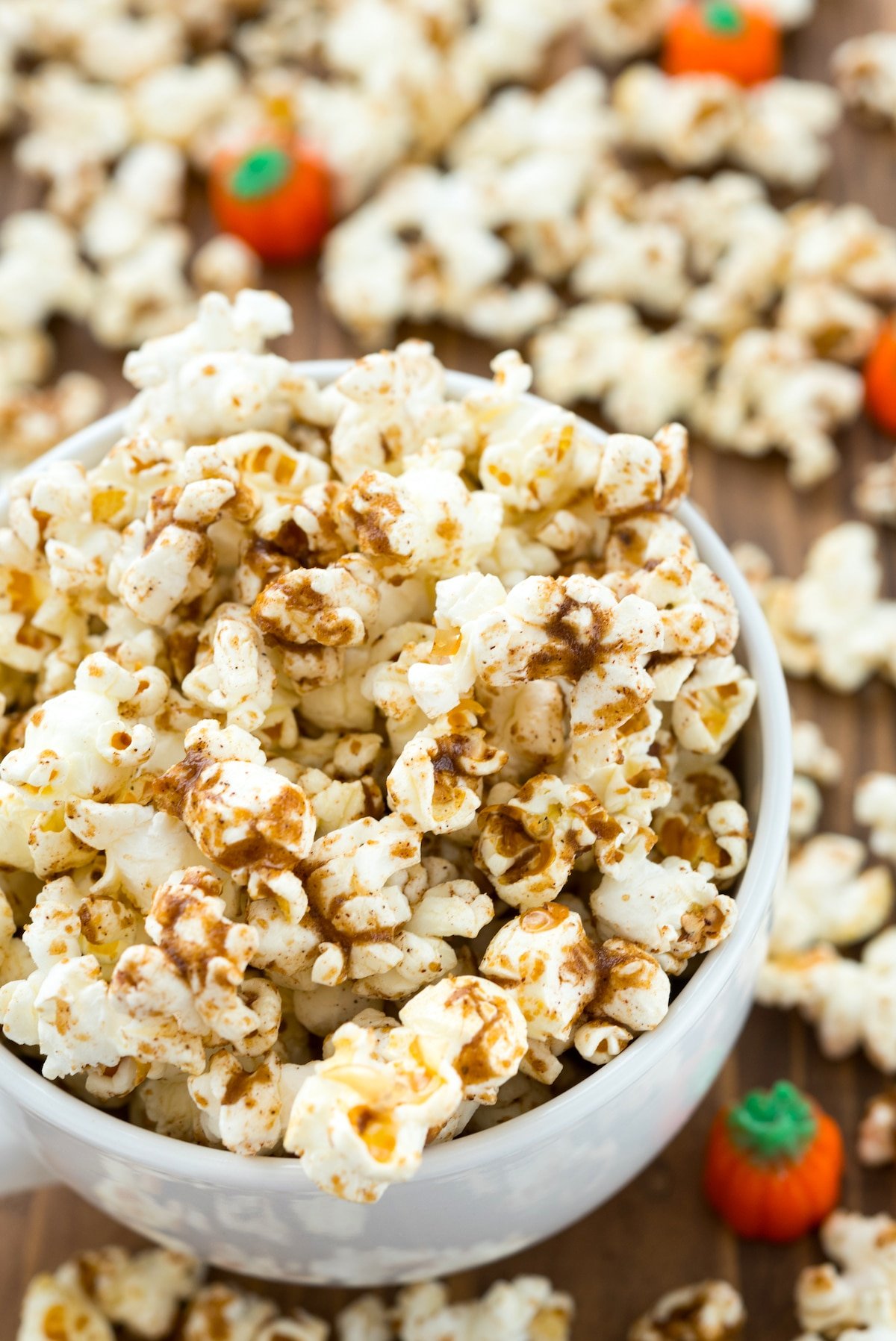 popcorn dusted with pumpkin spice in a white cup