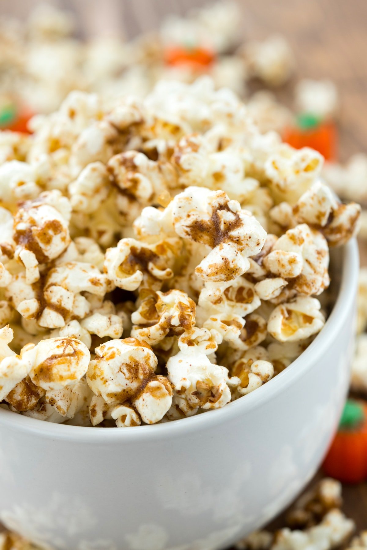 popcorn dusted with pumpkin spice in a white cup