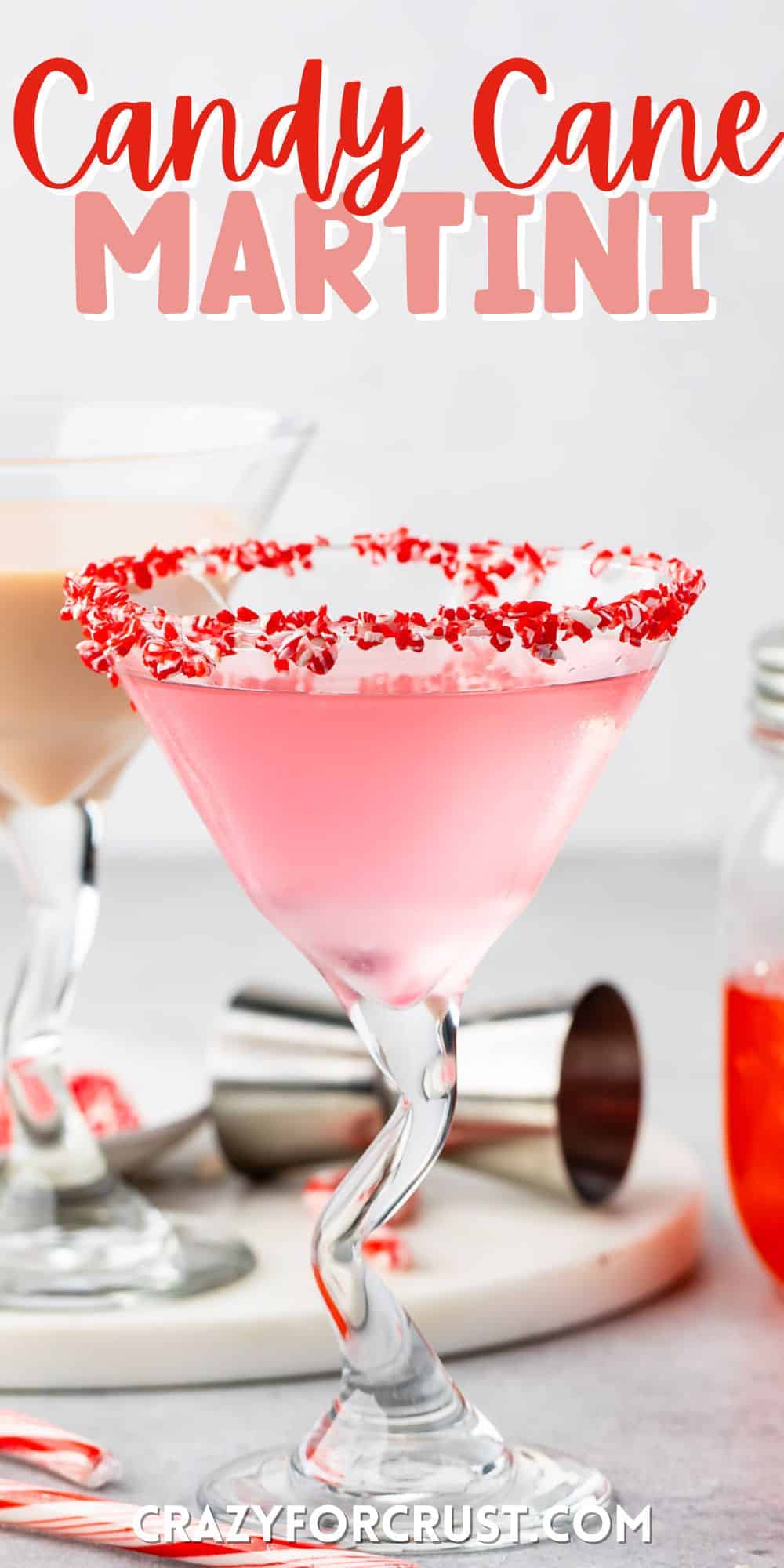 candy cane martini in a martini glass with crushed candy canes on the rim with words on top