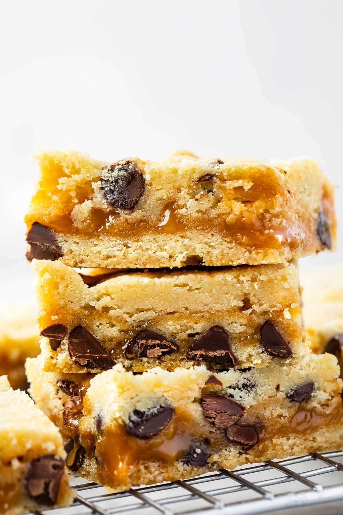 stack of 3 cookie bars with caramel and chocolate chips