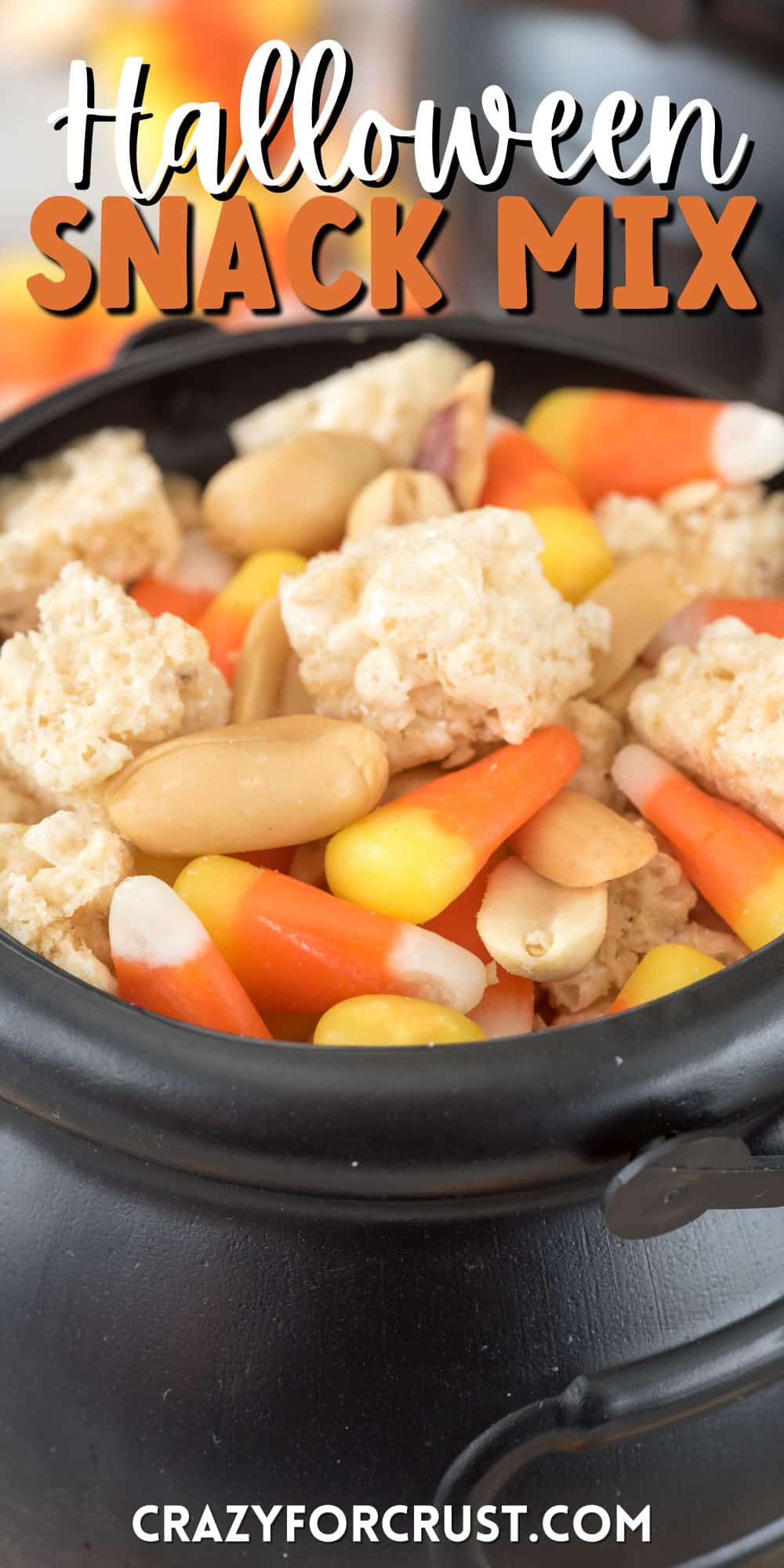 Krispie Treats and candy corn and nuts mixed together in a black cauldron with words on top