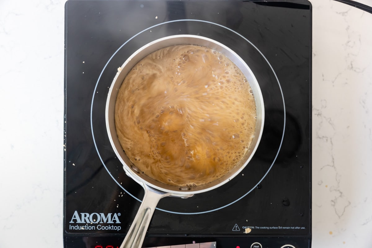 boiling sauce in pan on hot plate.