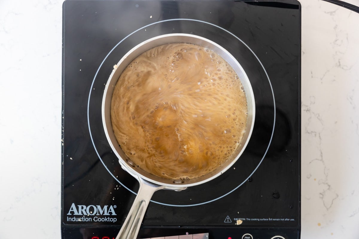 boiling sauce in pan on hot plate.