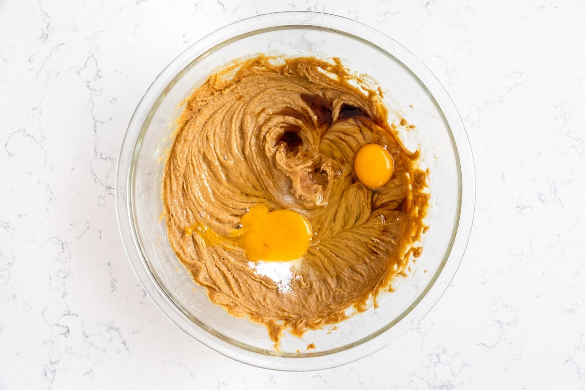 bowl of peanut butter cookie mixture with eggs