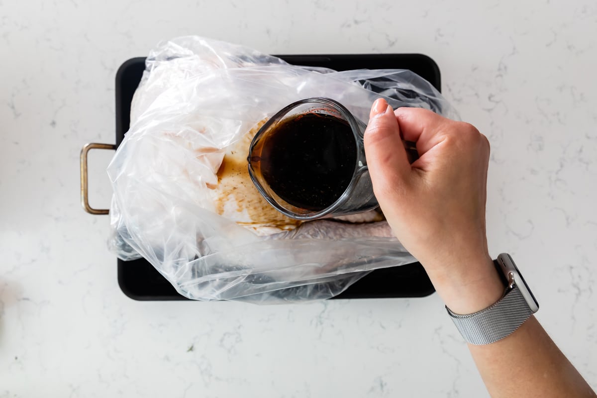 pouring baste into oven bag.