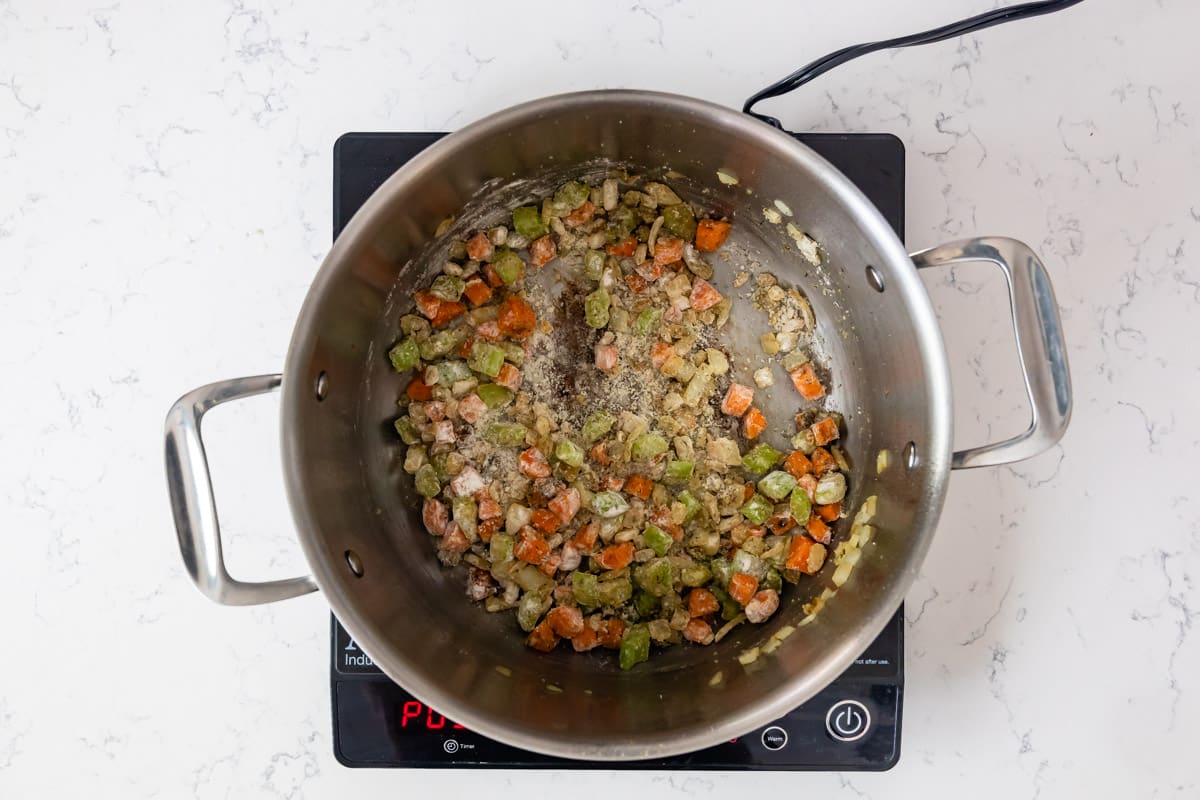 pan on hot plate with bacon and vegetables cooking.