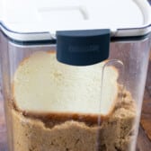 storage container with brown sugar and a slice of bread inside