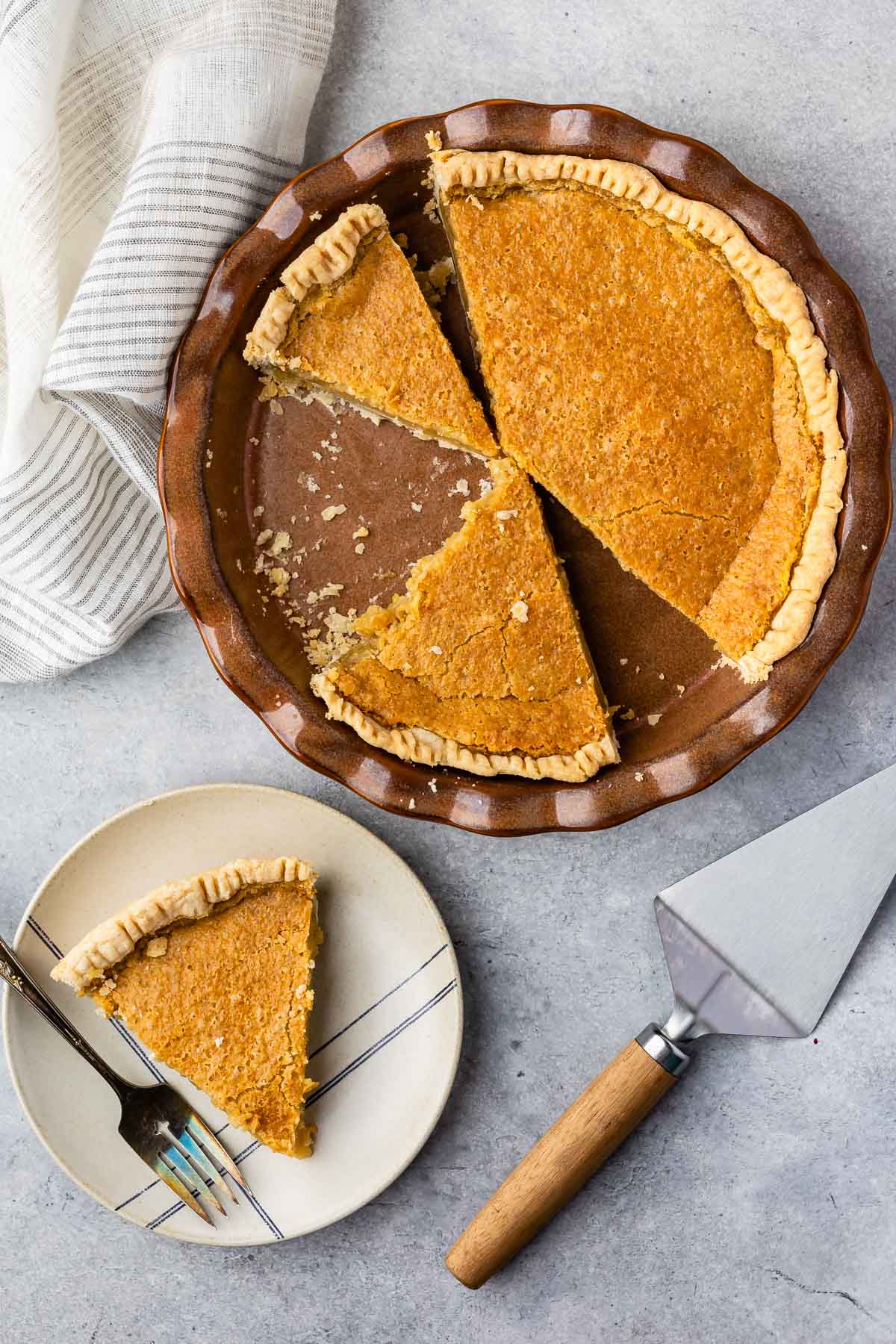 multiple slices of maple chess pie on a tan plate next to a fork and in a pie pan