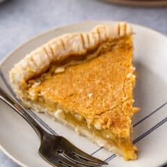 slice of maple chess pie on a tan plate next to a fork