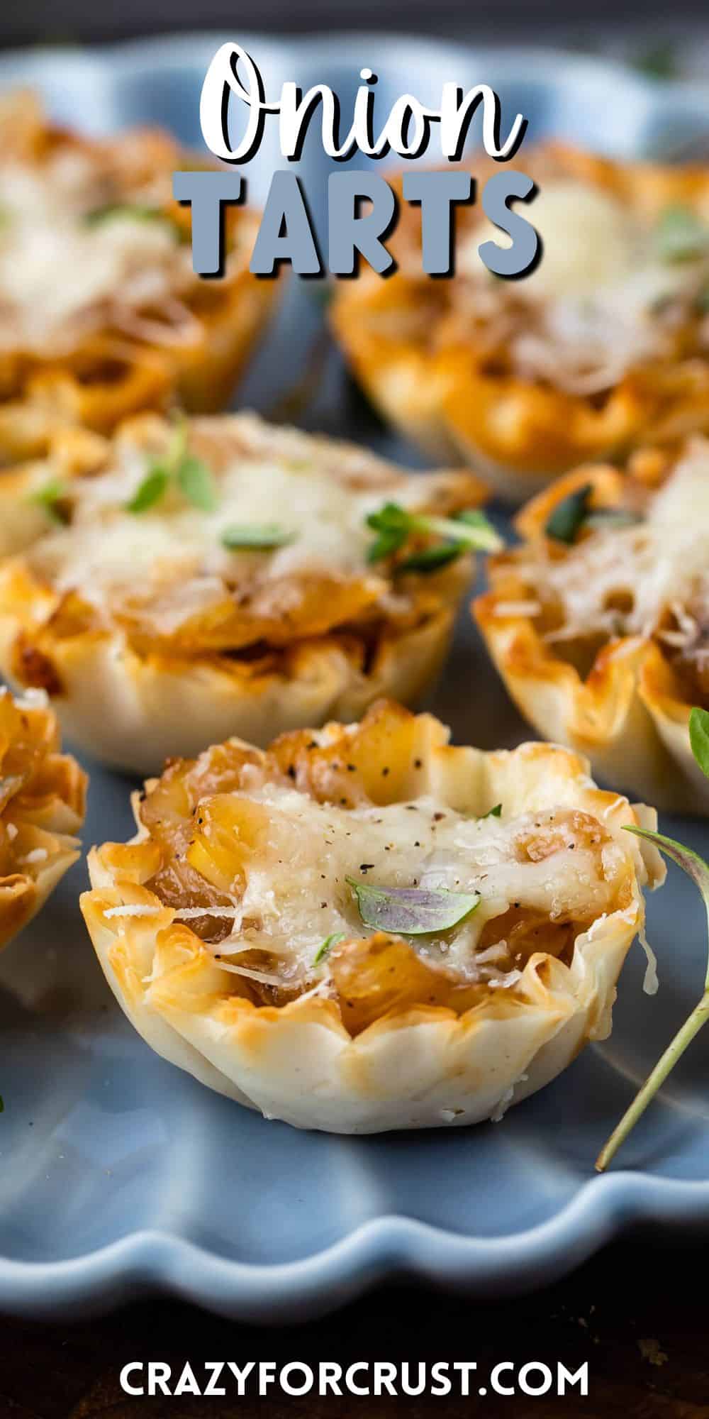 onion tart on a blue plate with words on the image