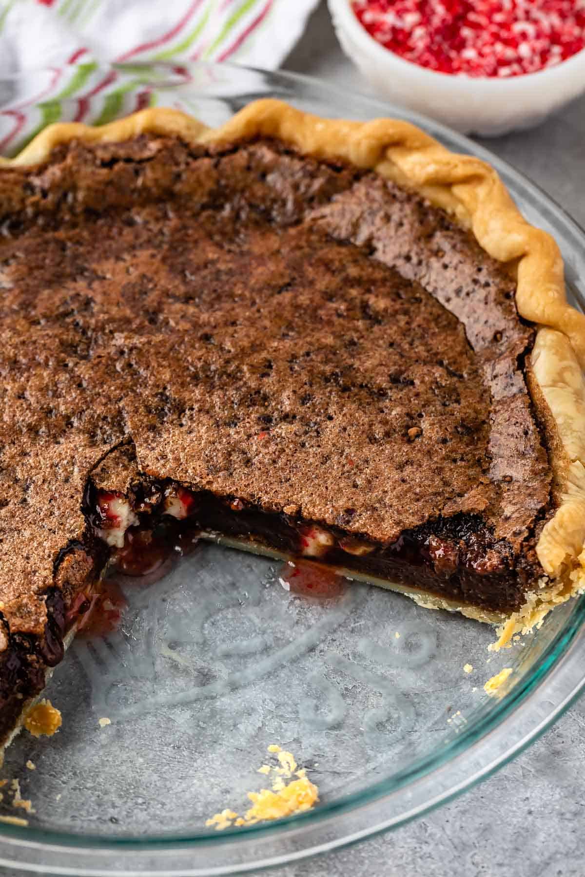 full chocolate chess pie in a clear pie pan