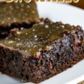 brownie on a white plate and topped with caramel and words on the image