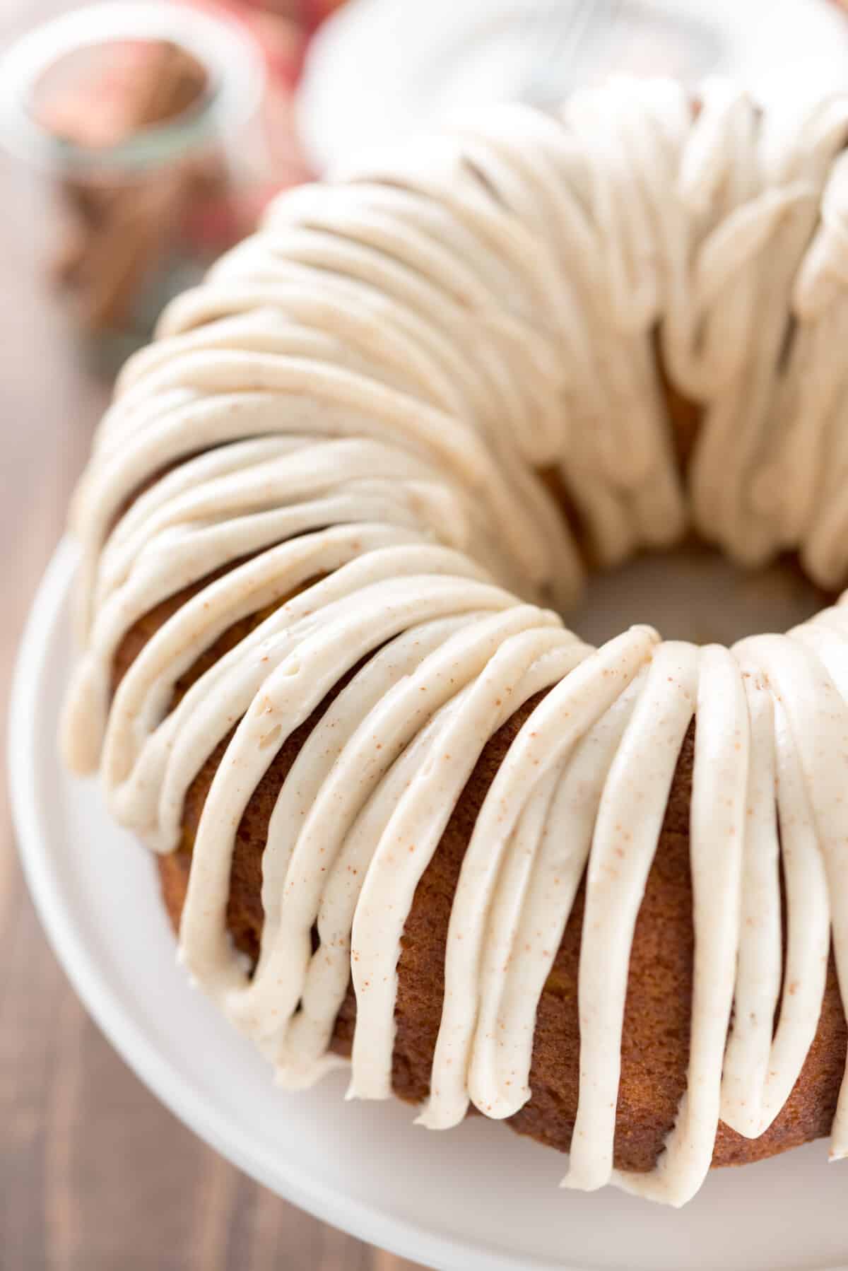 pumpkin bundt cake with frosting on top in a white platter