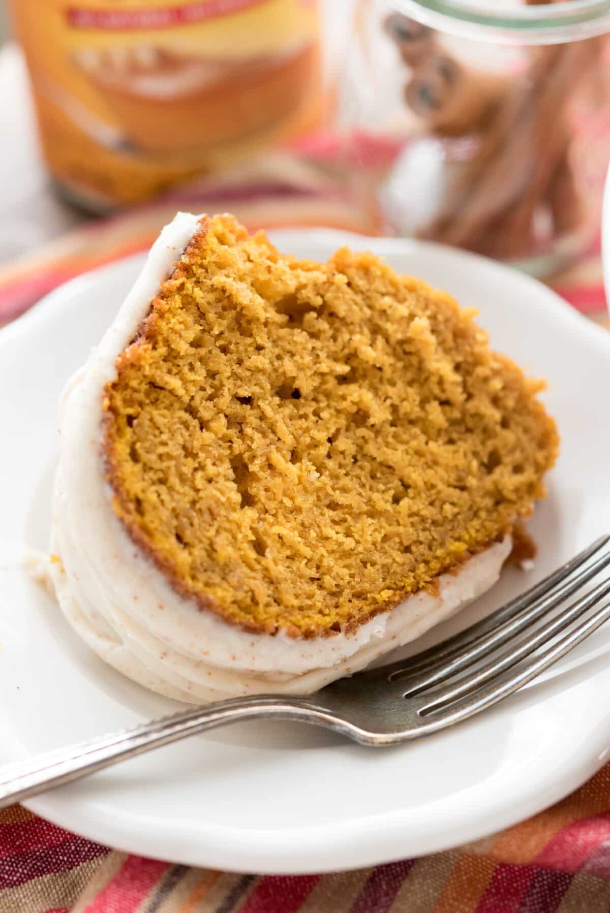 pumpkin bundt cake with frosting on top in a white platter