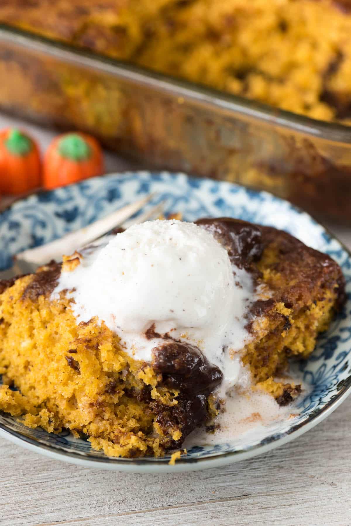 hot fudge cake in a blue bowl with ice cream on top