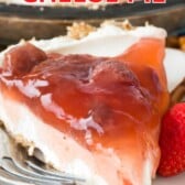 slice of cream cheese pie on white plate with strawberry topping