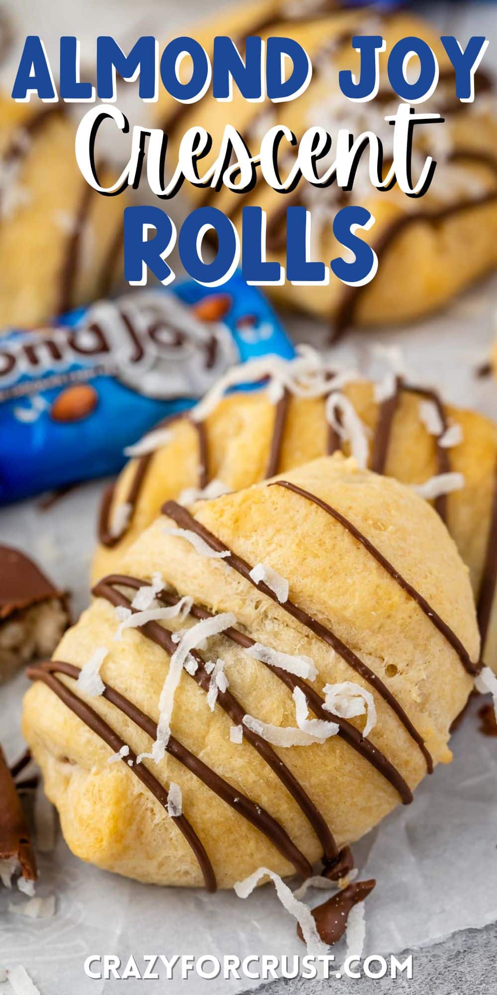 crescent rolls laid out on parchment paper with words on top