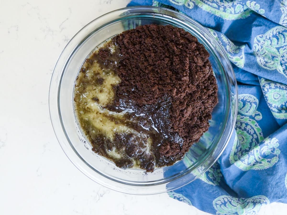 oreo cookie crumbs and melted butter in bowl